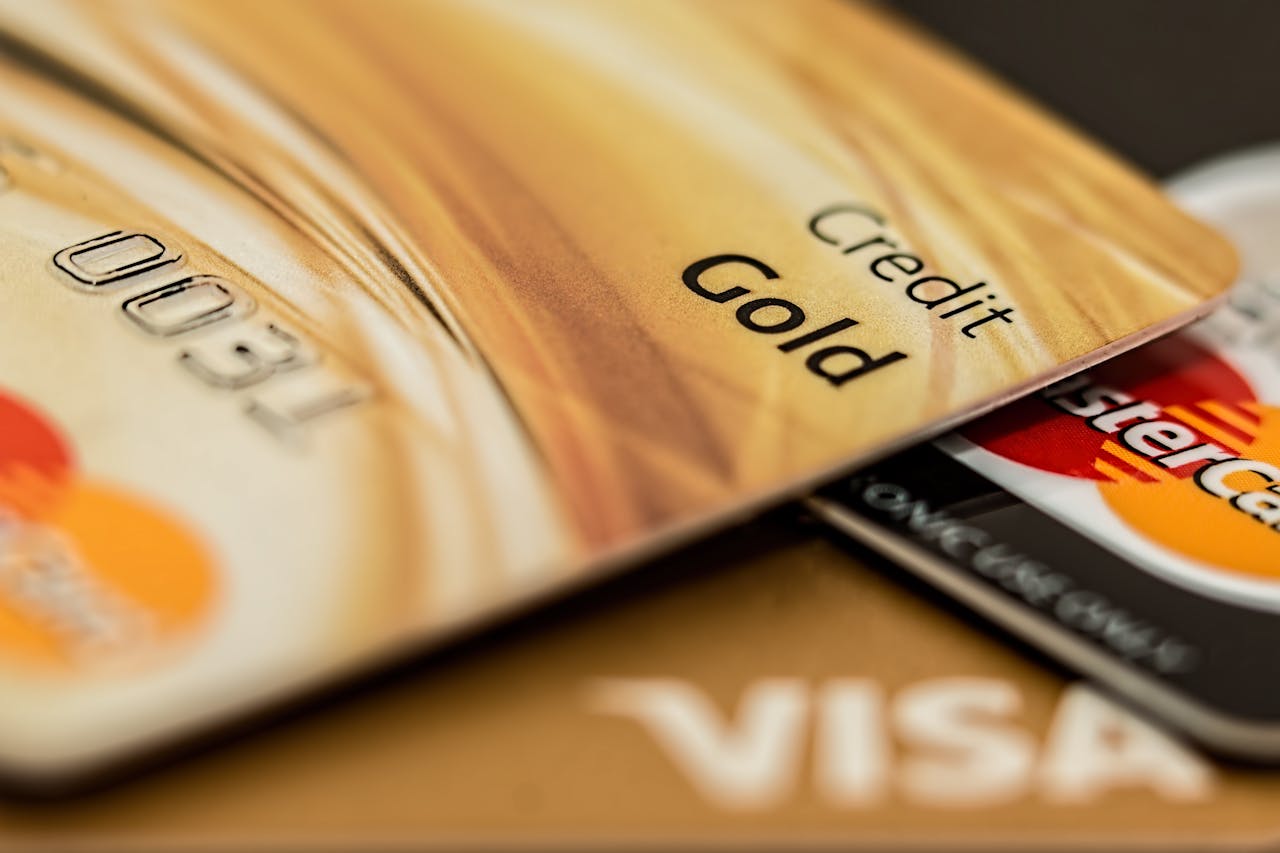 about-img Stack of various branded credit cards focusing on gold card showing finance and cashless concept.