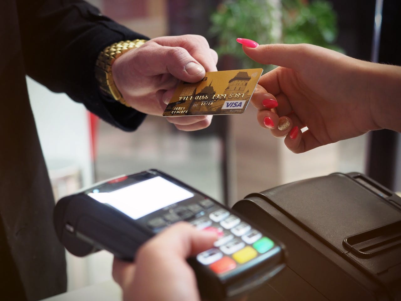 hero-img-02 Close-up of a credit card payment being processed at a POS terminal.